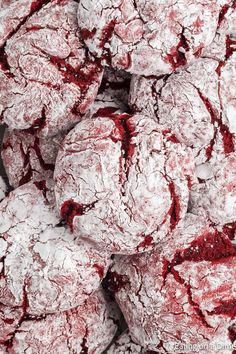 a pile of red velvet cookies covered in powdered sugar