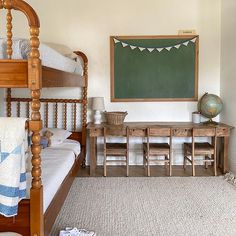 a child's bedroom with a chalkboard on the wall and wooden bed frame