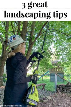 a woman is using a leaf blower to cut down the leaves on a tree