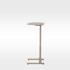 a small table with a metal base and a white top on an isolated grey background