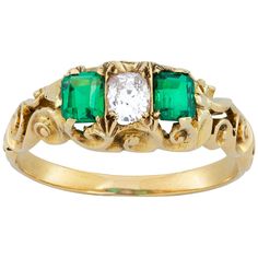 A late Victorian emerald and diamond three stone ring, the oval-cut diamond weighing approximately 0.30 carats set between two emerald-cut emeralds, weighing approximately a total of 0.60 carats, all se in a yellow gold carved mount with scroll decorations, to a yellow gold D-shape shank, circa 1890, head measuring 0.8x1.3cm, gross weight 4.0 grams. This ring is in very good condition, with signs of abrasion on the emeralds, consistent with the age of the ring. Unmarked, tested as 14ct gold. Thi Emerald Three Stone Ring, Diamond Three Stone Ring, Three Stone Ring, Victorian Gold, Victorian Rings, Bespoke Jewellery, Oval Cut Diamond, Three Stone Rings, Emerald Diamond