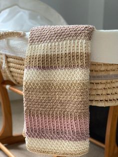 a knitted towel hanging from a wooden chair