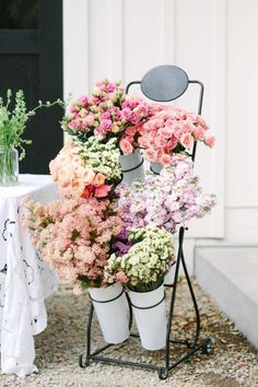 a bunch of flowers that are sitting on a stand