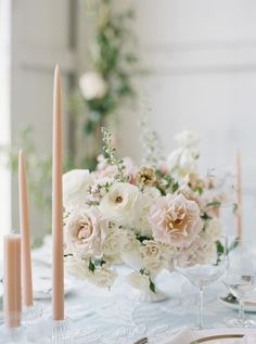 the table is set with flowers and candles