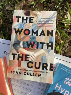 the woman with the curve by lynn cullen is on top of books in front of some plants