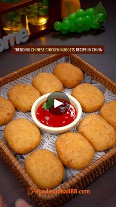 fried chicken nuggies in a basket with ketchup and sauce on the side