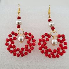 Sparkling red bead earrings, handmade and designed at home for this shop.  Earrings are made with shiny red crystal beads woven with gold colored wire and gold seed beads.  There is a 10mm pearl bead hanging into the center. with a 5.5 centimeter length. They are perfect for any occasion and add a sophisticated, classy look to any outfit.  please check out our shop for similar listings: https://www.etsy.com/shop/JewelryWheel?ref=search_shop_redirect Red Dangle Pearl Earrings For Festive Occasions, Red Beaded Crystal Drop Earrings, Red Beaded Drop Crystal Earrings, Handmade Red Pearl Earrings For Party, Red Gold Beaded Drop Earrings, Red Pearl Earrings As A Gift, Red Dangle Pearl Earrings, Red Dangle Pearl Earrings For Jewelry Making, Handmade Red Pearl Earrings