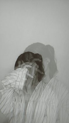 a black and white photo of a person with their head in the back of a shirt