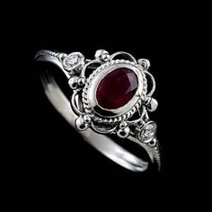 Victorian Oval Ruby Diamond Twisted Swirl Design Open Filigree 14K White Gold Bezel Set Engagement Ring Stunning, romantic Victorian style engagement ring made of 14K white gold. Features a bezel set oval ruby (~1/2ct) and two small diamonds (.06cttw, G-SI1 quality). Stones are enveloped in intricate open filigree and twisted wire design giving the ring the vintage luscious feel. Sizes: 4-8 (smaller and larger sizes are available as custom orders.) PROUDLY MADE FROM SCRATCH IN NEW YORK CITY. Ple Oval Ruby Engagement Ring, Victorian Engagement Rings, Dresses Classy, Ruby Engagement Ring, 925 Silver Jewelry, Jewelry Wedding, 925 Jewelry, Ring Vintage, Styl Vintage