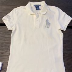 Ralph Lauren Us Open Tennis Polo With Silver Horse. Brand New, Size Small. Fitted White Ralph Lauren Top, Us Open Tennis, Horse Brand, Tennis Polo, Silver Horse, Ralph Lauren Logo, Polo Ralph Lauren Women, Ralph Lauren Sport, Purple T Shirts