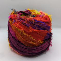 a multicolored ball of yarn on a white surface