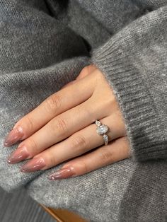 a woman's hand wearing a diamond ring