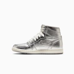 Air Jordan 1 Retro HighWomen's ShoesEvery Jordan Retro is a classic sneaker done up in new colors and textured for a fresh look. Shiny metallic cracked leather and a tinted translucent outsole help this iteration bring all your chrome dreams to life. Premium materials and accents keep the look modern and on point.Leather offers durability and structure.Encapsulated Air unit provides lightweight cushioning.Rubber outsole helps give you traction on various surfaces. Color: Silver Photon Dust Sail Nike Air Force High Tops, Air Force High Tops, Nike Air Force High, Air Force High, Jordan Shop, Formal Ideas, Kids Belt, Womens Air Jordans, Jordans Women