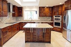 a kitchen with marble counter tops and wooden cabinets