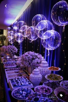 a buffet table with balloons and food on it