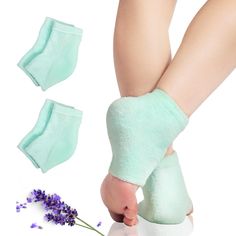 a woman's feet with green socks and lavenders next to her foot pads