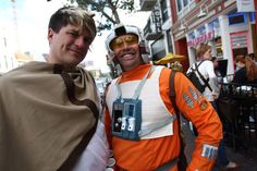 two men dressed in costumes standing next to each other