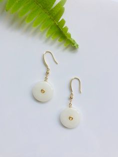 A pair of dainty genuine white jade earrings hand-made with 925 sterling 18k gold plated modern design hanging drop hooks in drop/dangle style! The delicate white jades come from Burma and are grade-A Gemstones. The rest parts are handmade with high-quality 925 Sterling Silver plated with 18k gold. Traditional Round or circle White Jade is a symbol of peace in Chinese culture. The Simple and stylish design shows a taste of elegance and modernness. Some features of these eye-catching white jade e White Jade, Jade Earrings, Ringe Gold, Black Gift, Chinese Culture, Matching Bracelets, Jade, 18k Gold, Jewelry Earrings Dangle