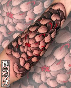 this is an image of a tattoo with flowers on the forearm and arm, done in black and grey ink