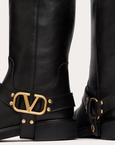 Valentino Garavani calfskin ankle boot with VLogo Signature decoration - Removable strap with VLogo Signature detail in antique brass finish - Rubber sole - Heel height: 30 mm / 1.2 in. - Boot shaft height: 22 cm / 8.6 in. in an Italian size 37 - Made in Italy Luxury Moto Boots With Buckle Closure For Fall, Designer Moto Boots With Buckle Closure In Calf Leather, Luxury Formal Moto Boots With Buckle Closure, Designer Calf Leather Moto Boots With Buckle Closure, Luxury Moto Boots With Leather Lining For Fall, Luxury Leather Lined Moto Boots For Fall, Luxury Leather-lined Moto Boots For Fall, Luxury Fall Boots With Buckle Closure, Gold Luxury Calf Leather Boots