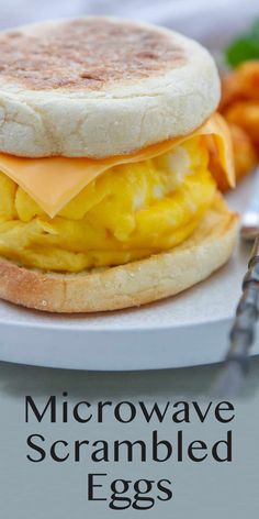 an egg and cheese sandwich on a white plate with carrots next to the words microwave scrambled eggs