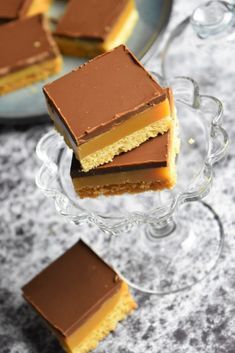 three pieces of cake sitting on top of a glass plate