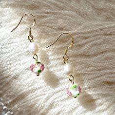 Beautiful handcrafted garden rose flower glaze ball dangle earrings with natural pearl, truly a piece of delicate art! Gorgeous exquisite pink and green floral pattern color glaze, miniature rose and leaf looks like real and vivid inside the sphere. ♥ Colored glaze is a kind of crystal, inherits the essence of Asian traditional plastic arts. Its soft curve, gorgeous color and various appearances give colored glaze translucent color and intense conditioning. 💎 Features: ♥ Material: Finest 14K Go Delicate Pink Pearl Earrings For Gift, Delicate Pink Pearl Earrings As Gift, Green Pearl Earrings For Gift, Green Pearl Earrings As Gift, Handmade Pearl Flower Earrings Gift, Handmade Pearl Flower Earrings For Gift, Elegant Flower Earrings With Round Beads As Gift, Elegant Round Beads Flower Earrings As Gift, Elegant Pink Round Bead Flower Earrings