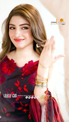 a woman in a red and black dress is holding her hand up to the side