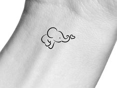 an elephant tattoo is shown on the side of a white leather seat cover with black ink