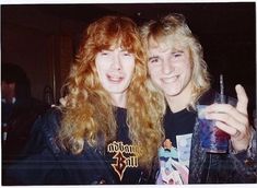 two young women posing for the camera with drinks in their hands