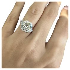 a woman's hand with a diamond ring on it