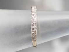 This is a classic wedding band made impressive by the quality of its materials! Crafted of 14 karat white gold, this ring has a bright polish that pairs perfectly with the bright double-stacked diamonds set into it. When worn, this band displays a full row of intense, light-filled sparkle.Metal: 14K White GoldGem: 30 Diamonds totaling .30 Carats, SI1 in Clarity, H in ColorWidth of Band: 2.6 mmHeight off Finger: 1.8 mmRing Size: 5.50Marks: “14K” Stamped on the inside band White Gold Diamond Band, Diamond Stacks, Classic Wedding Band, Diamond Rings Bands, Classic Wedding, Diamond Band, Diamond Bands, White Gold Diamonds, Wedding Band