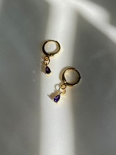 "18K gold plated teardrop amethyst, emerald drops huggie hoops which are beautifully shiny under the sunlight. *Nickel free 👀 Details 👀 * Materials : 18K gold plated brass, Amethyst, Emerald * Hoop style * 10mm hoop diameter (Inner diameter : 8mm) Crystal charm : 3 mm (w) x 6 mm (h) * Product is non-returnable for hygiene ⚠️Tips for caring⚠️ -Keep jewelry dry (Avoid contact liquid) -Store difference type of jewelry separately -Store jewelry in a small zip lock bag 📦 Packaging 📦 These earring Anniversary Gold Plated Teardrop Huggie Earrings, Anniversary Teardrop Gold Plated Huggie Earrings, Anniversary Teardrop Gold-plated Huggie Earrings, Purple Hoop Earrings As Gift, Gold Amethyst Dainty Earrings, Dainty Gold Amethyst Earrings, Gold Plated Teardrop Huggie Earrings, Tarnish Resistant Teardrop 14k Gold Filled Huggie Earrings, Gold Plated Teardrop Earrings For Gift