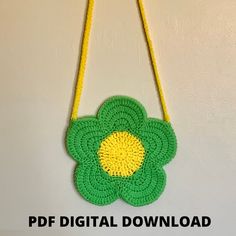 a crocheted flower is hanging on the wall