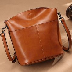 Features: Vintage cowhide leather L 9.0 x W 4.7 x H 11.0 Inch About 1.3 Ibs Two outside pockets infront Two main sections for phone, umbrella, wallets and more Adjustable leather strap Availabel in Brown, Green, Wine Red, Black Leather Shoulder Bag With Cell Phone Pocket For Fall, Fall Leather Shoulder Bag With Cell Phone Pocket, Leather Phone Shoulder Bag For Office, Leather Shoulder Phone Bag For Office, Brown Leather Phone Bag For Office, Solid Leather Large Capacity Phone Bag, Large Capacity Leather Phone Bag, Brown Phone Bag For Office, Everyday Leather Phone Bag With Large Capacity