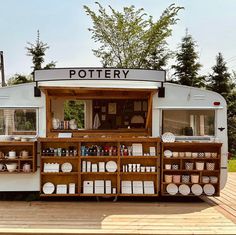 a small food truck with lots of items on it's display shelf and shelves