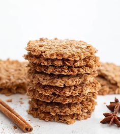 several cookies stacked on top of each other next to cinnamon sticks and star anise