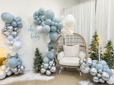 a room decorated for christmas with balloons and snowflakes