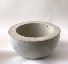 a concrete bowl sitting on top of a white table