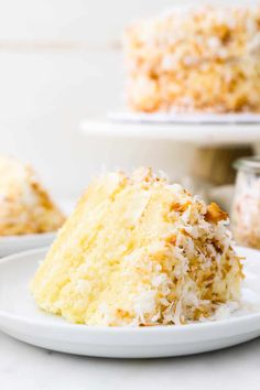 a close up of a slice of cake on a plate with another piece in the background