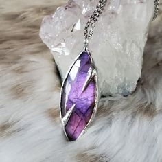 "Part of the Vortex Collection, released on the Solar Eclipse, this magical piece features a stunning, purple labradorite. Labradorite is a stone of protection, transformation and magick!  This handmade beauty hangs from a 16\" stainless steel chain with 2\" extender.  The material used to adorn the stone is called silver soft solder, which is a metal alloy comprised of tin & silver. Your order will arrive gift boxed with care instructions included.  Please let me know if you have any questions. Spiritual Labradorite Crystal Necklaces For Jewelry Making, Spiritual Labradorite Necklaces With Raw Stone, Spiritual Labradorite Necklace With Raw Stone, Mystical Iridescent Gemstone Necklace, Mystical Labradorite Healing Jewelry, Mystical Labradorite Jewelry For Healing, Mystical Handmade Iridescent Necklaces, Mystical Handmade Iridescent Necklace, Electroformed Labradorite Necklaces For Healing