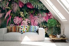 a living room filled with furniture and wallpaper covered in pink leaves on the walls