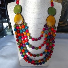 This Is Organic Vegan Jewelry Made By A Master Artisan Jewelry Maker From Ecuador. Multistrand, Multicolor With Matching Pink Earrings. The Sliding Cord Allows To Wear The Necklace At A Length That Goes Best With The Outfit. Multi Color Allows This Jewelry To Match Many Outfits. Tagua Nut Is A Product Of Tagua Palm Trees That Grow In Ecuador's Amazon Rainforest. Your Purchase Allows Treasure Of Andes To Place New Orders With Artisans' Families. Thanks For Looking, All Questions Ate Welcome. Vibrant Multicolor Handmade Necklaces, Vibrant Rainbow Jewelry With Colorful Design, Handmade Multi-tone Jewelry Gift, Colorful Wooden Beads Jewelry For Gift, Colorful Wooden Beads Jewelry As Gift, Colorful Wooden Beads Jewelry As A Gift, Colorful Wooden Beads Jewelry Gift, Puerto Rican Jewelry, Fair Trade Multicolor Jewelry For Beach