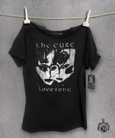 The Cure T Shirt This is a great Cure T shirt featuring the classic Lovesong image Printed by hand with Antique Silver which has a soft hand and a slight vintage feel. 1 colour print on 100% ethically sourced cotton tee. Feels and fits like a well-loved favourite T shirt Hand Screen Printed by me for all you connoisseurs of culture out there. Distressed looking design on black tee. No Digital No Print On Demand No Transfers No Third Party Unisex shirts: Wide - measure across garment 1cm down from armholes Length - measure from highest point of the shoulder to bottom edge small - 50cm wide & 70cm long medium - 53cm wide & 72cm long large - 56cm wide & 74cm long Women's regular fitted t-shirt Wide - measure across garment 1cm down from armholes Length - measure from highest point of the shou Metal Band Shirts, Black Tees, Y2k Tops, Baby Tees Y2k, Colour Print, Women T Shirts, Third Party, Soft Hand, Unisex Shirts