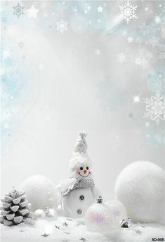 a snowman is surrounded by balls and pine cones