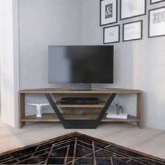 a flat screen tv sitting on top of a wooden entertainment center in a living room