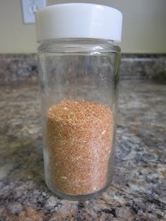 a glass jar filled with sand sitting on top of a counter