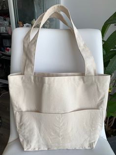 Canvas tote bag is ideal for a trip to the beach or for that quick weekend getaway!  Perfect for everyday, baby mommy bag, quick grocery trip, work bag, craft project bag, or can be used as a gift bag or for your bridal party. Natural textured canvas with 2 large exterior pockets and long comfortable double handles. Measurements: Body (w x h x d): 28 x 30.5 x 12 cm (11 x 12 x 4.75 in.) Handle drop: 30.5 cm (12 in.) If you have any queries, please leave a message. Thank you for visiting us. Eco-friendly Canvas Bag With Removable Pouch For On-the-go, Eco-friendly On-the-go Bags With Pockets, Beige On-the-go Diaper Tote Bag, Beige Rectangular Diaper Bag For Daily Use, Rectangular Beige Diaper Bag For Daily Use, Large Capacity Cream Tote Weekender Bag, Daily Use Tote Beach Bag With Pockets, Cream Rectangular Diaper Bag For Everyday Use, Cream Rectangular Diaper Bag For Daily Use