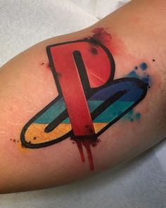 a person with a tattoo on their arm and the letter p painted on his arm