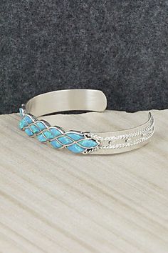 This beautiful opalite and sterling silver bracelet was made by Zuni silversmiths Derrick & Lorella Chavez. The back is signed and stamped sterling.Size: 5 1/4" (will fit up to a 6 1/2" wrist)Gap: 1 1/4"Width: 3/8"Free shipping on all orders! We ship with USPS and always include tracking. All orders ship within a day of payment.Returns are accepted up to 30 days after you receive your order. Just send us a message. Our shop offers cash back or store credit. The item must be returned in new condi Sterling Silver Inlay Bracelets In Silver Color, Silver Opal Jewelry For Collectors, Collectible Silver Opal Jewelry, Adjustable Sterling Silver Bracelet With Inlay, Sterling Silver Bracelet, Native American Jewelry, Free Jewelry, Sterling Silver Bracelets, Silver Bracelet